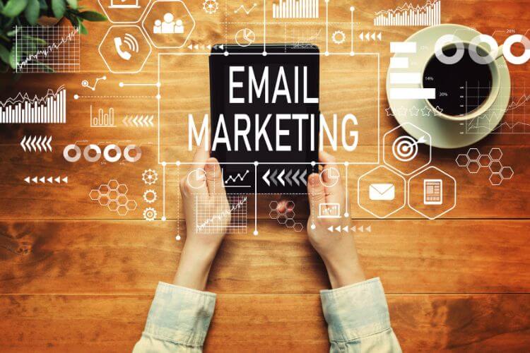 Hands holding tablet with 'Email Marketing' text and digital icons for AI-driven personalization strategy