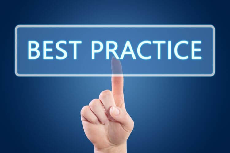 Finger pressing virtual 'Best Practice' button on blue digital interface for marketing automation tips
