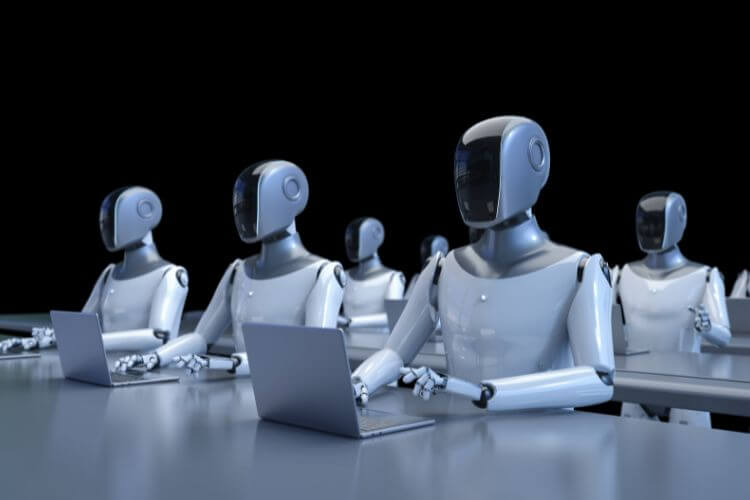 Humanoid robots working on laptops representing automation tools and AI-powered workflows