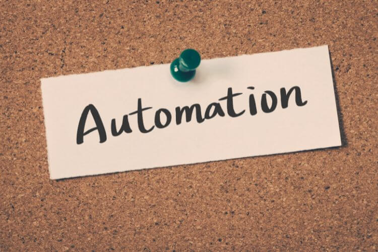 Corkboard with pinned note labeled 'Automation' highlighting broken or paused workflow processes