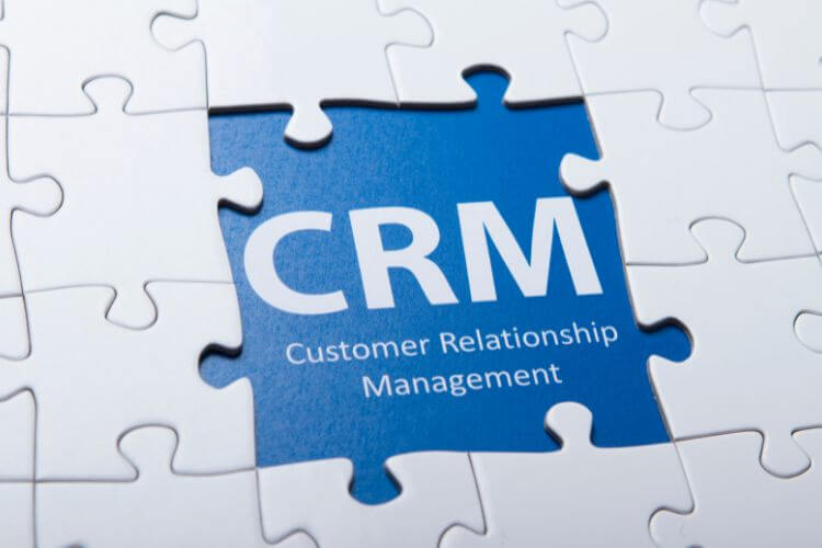 CRM puzzle piece representing customer relationship management automation strategies for B2B businesses