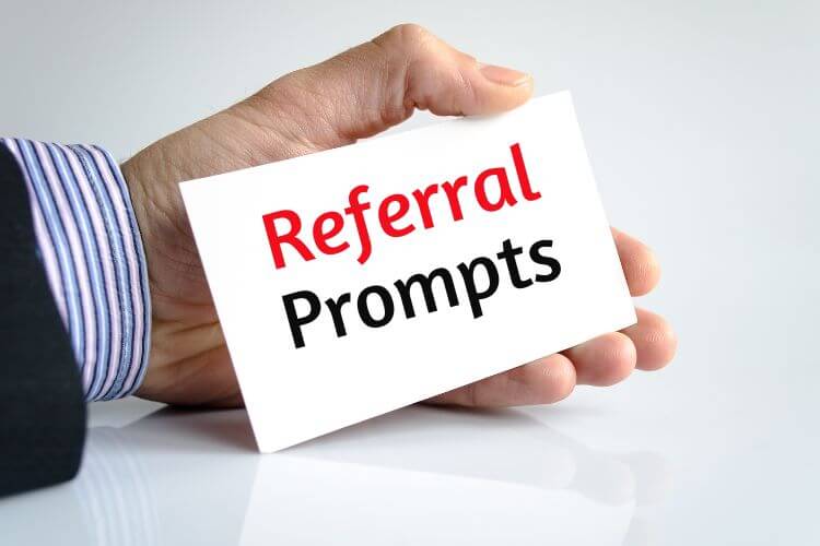Hand holding a card labeled 'Referral Prompts' highlighting developer-focused copywriting techniques