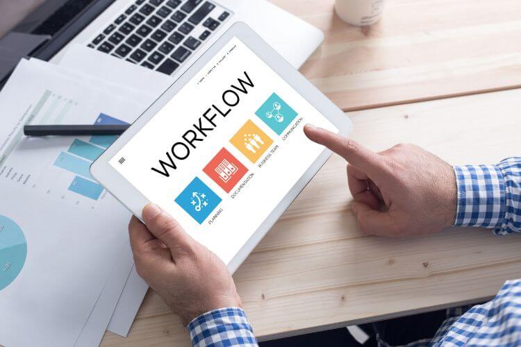 Tablet screen showing workflow management dashboard used in marketing automation planning