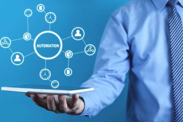 Marketing automation concept with digital icons showing interconnected tasks on tablet held by businessman
