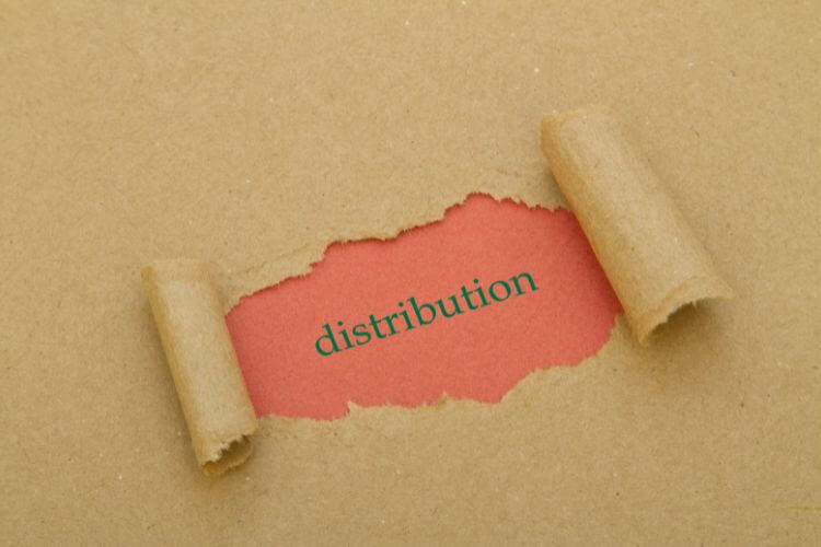 Torn kraft paper exposing the word “distribution” to illustrate distribution channels in marketing