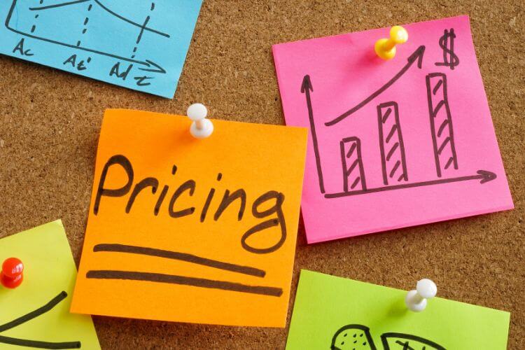 Colorful sticky notes highlighting pricing strategy with revenue growth chart on corkboard