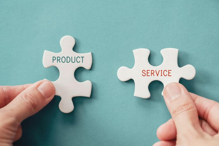 Hands join product and service puzzle pieces to depict product-service management in marketing