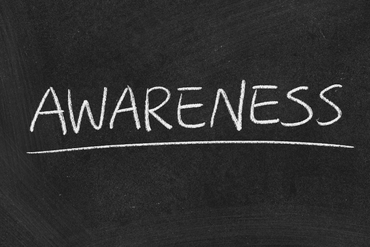 Chalkboard with the word 'Awareness' underlined in white chalk representing brand recognition