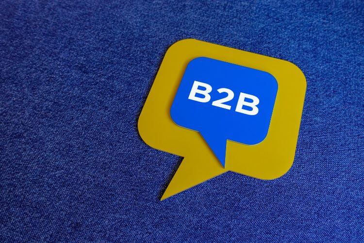 Blue and yellow B2B icon on textured background representing business-to-business podcast marketing strategy.