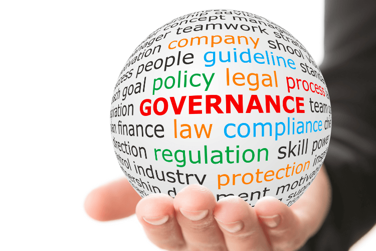 Hand holding a governance word cloud sphere representing database compliance, policy, and regulatory control