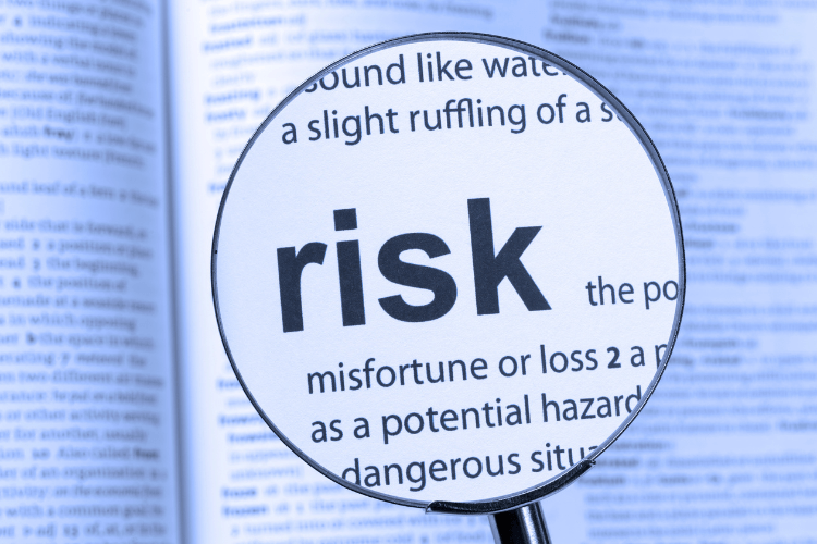 Magnifying glass highlighting risk in dictionary symbolizing ChatGPT data leak dangers