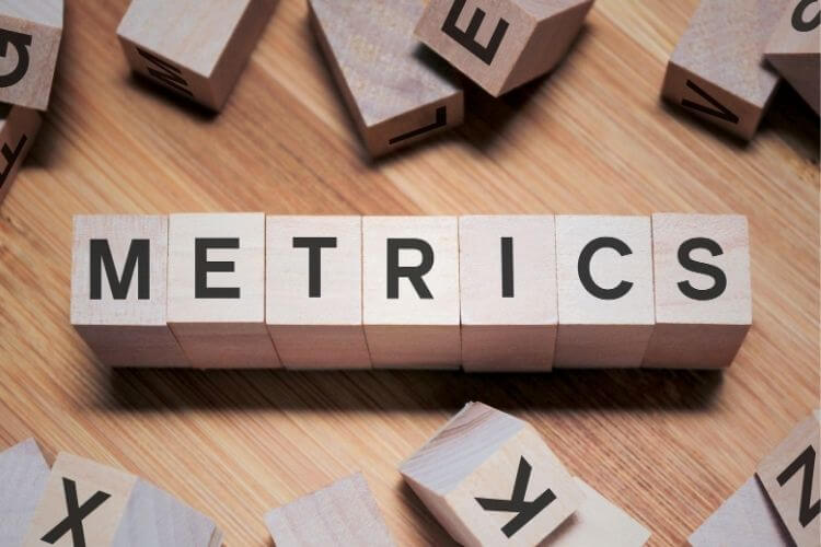 Predictive metrics concept with wooden blocks spelling out SaaS growth data