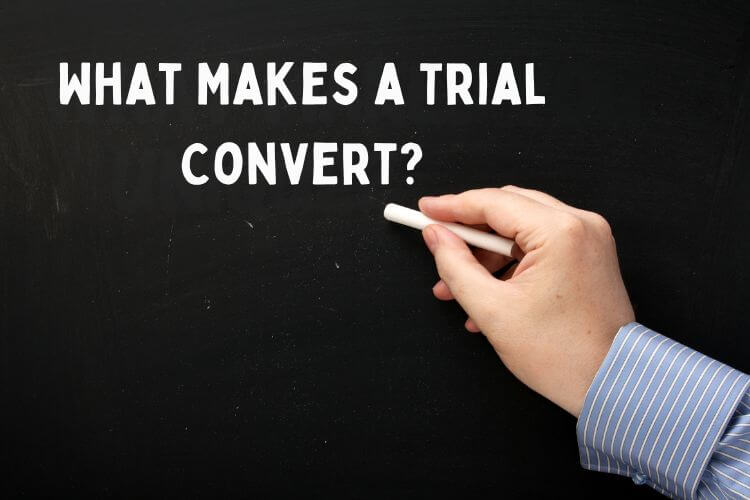 What makes a trial convert written on chalkboard with hand holding chalk